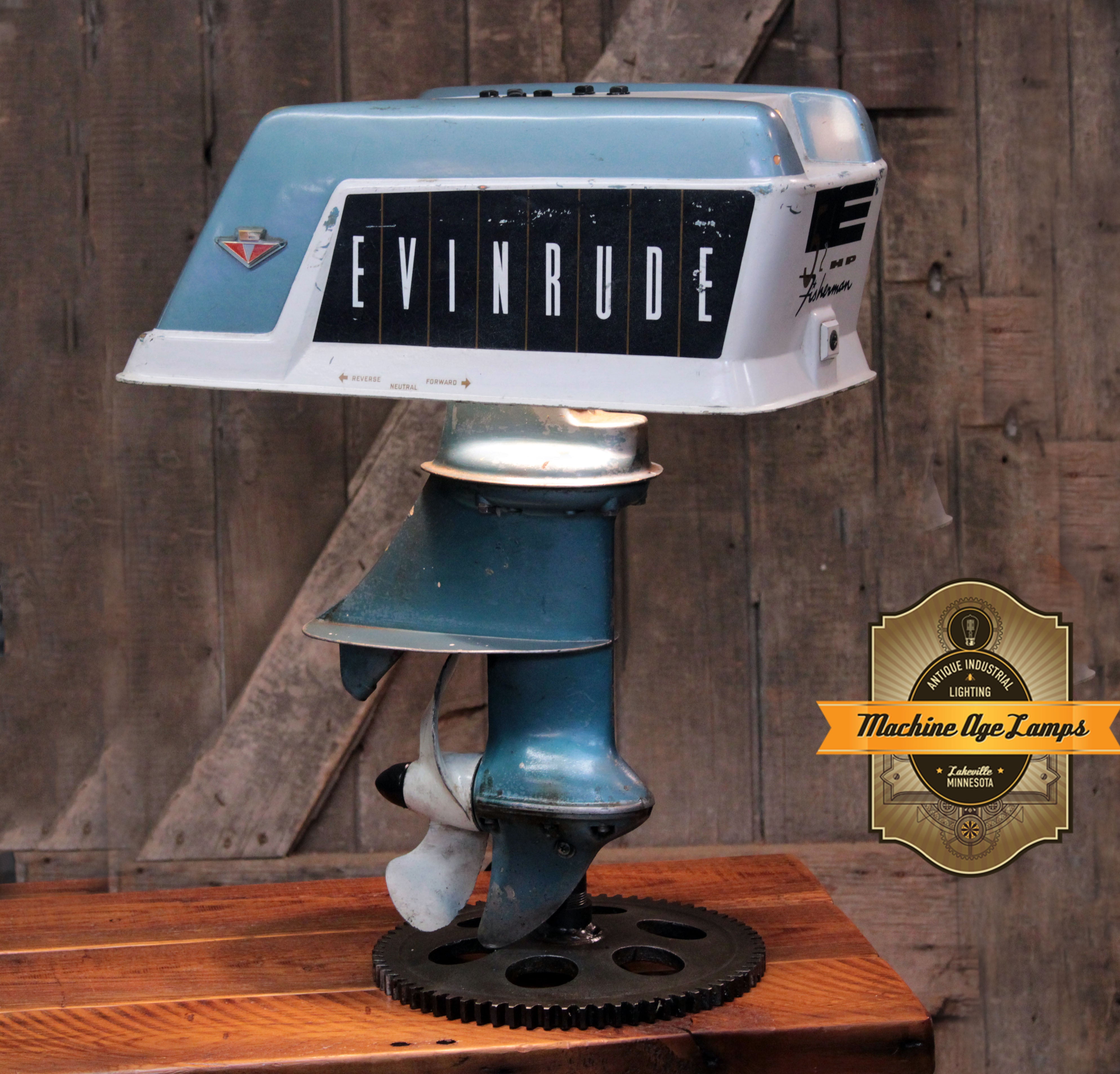 Handcrafted steampunk industrial lamp made from a vintage 1950s Evinrude boat motor.