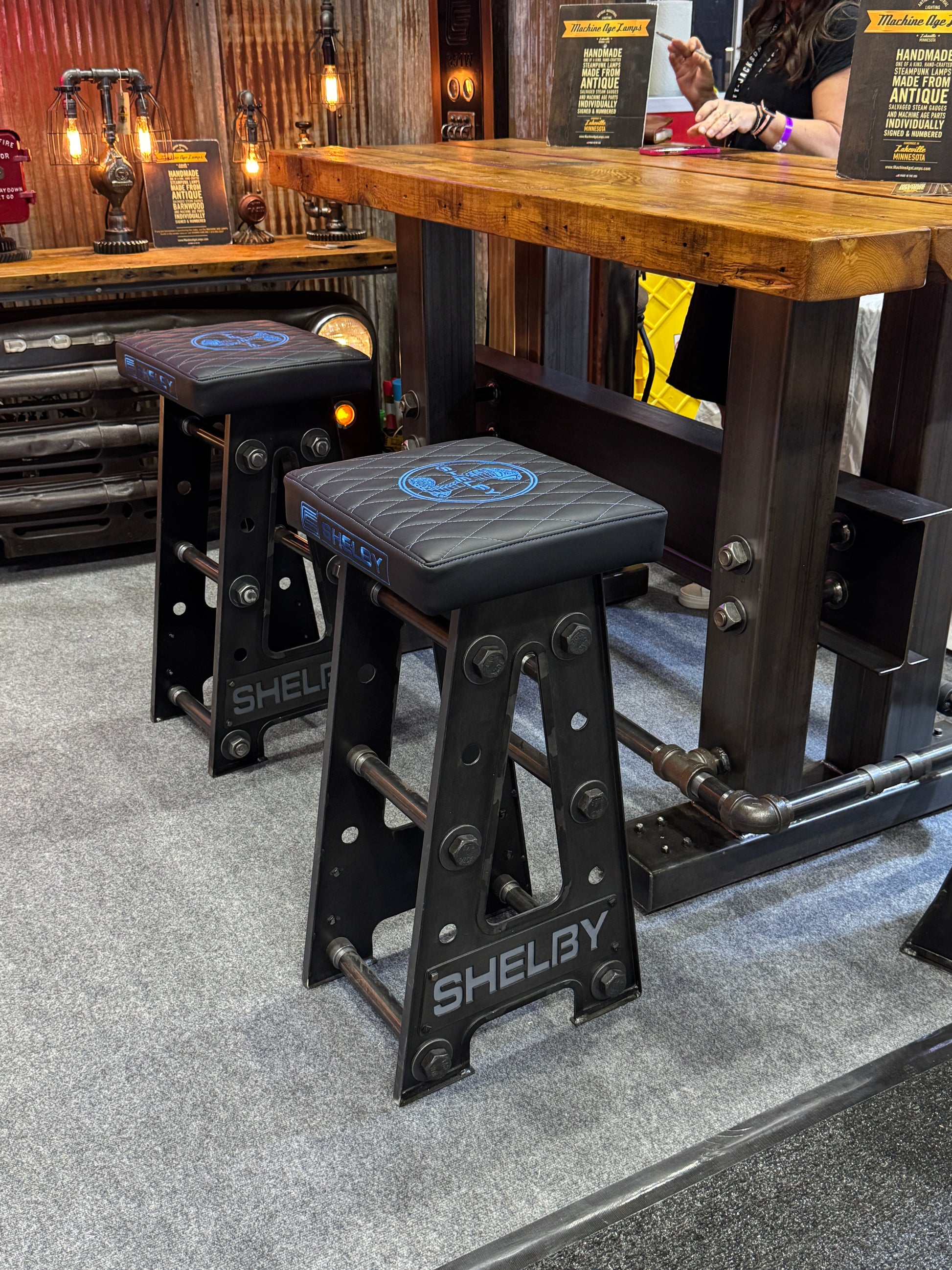 Industrial steampunk Carrol Shelby Barstool underneath bar