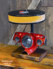 Custom made 1957 Chevy Bel Air dash lamp, steampunk industrial hot rod decor with barnwood base.
