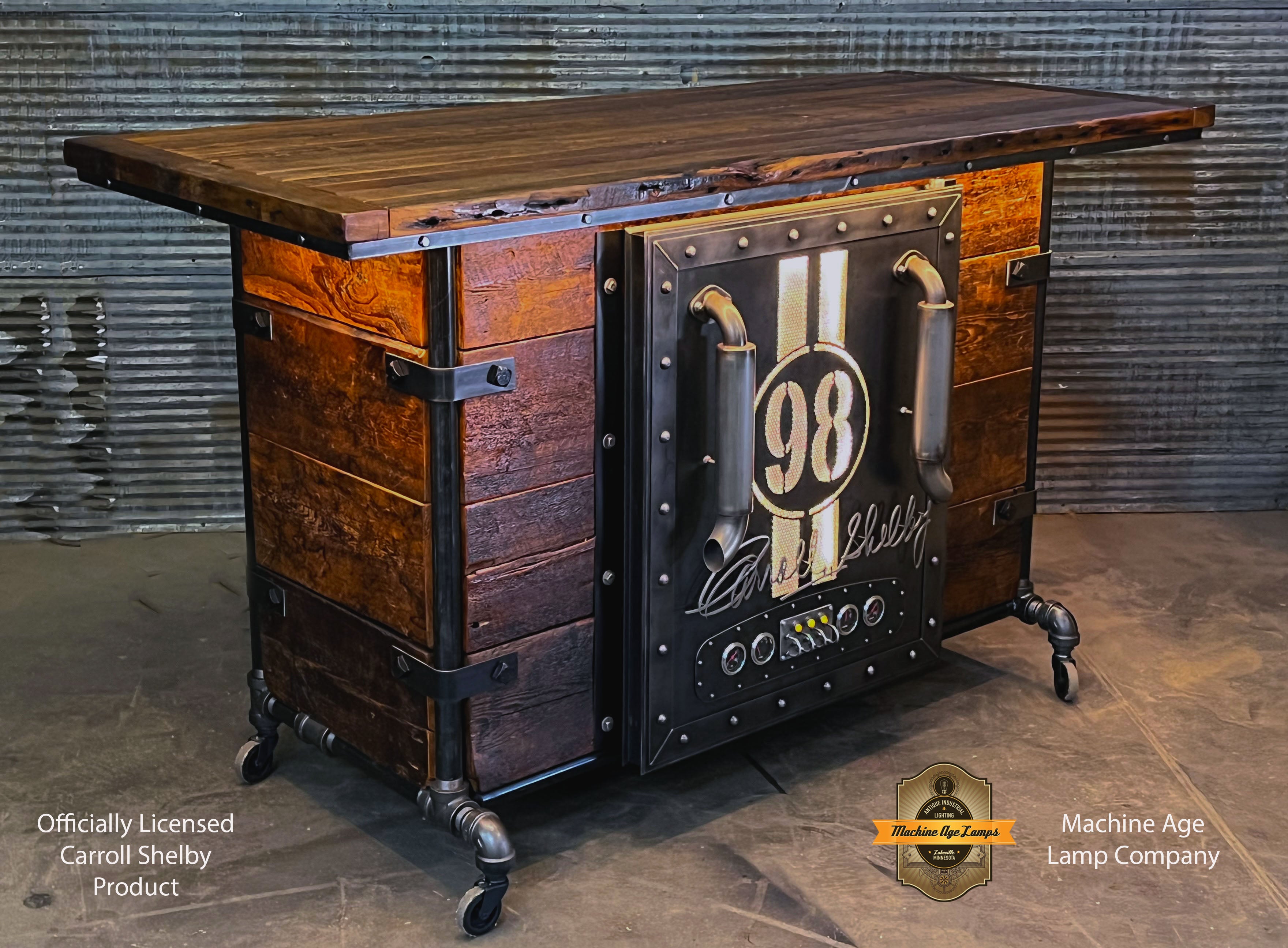 Antique barn wood refrigerator bar with a large door featuring a Carroll Shelby license plate number, LED lighting, and wheels for mobility.