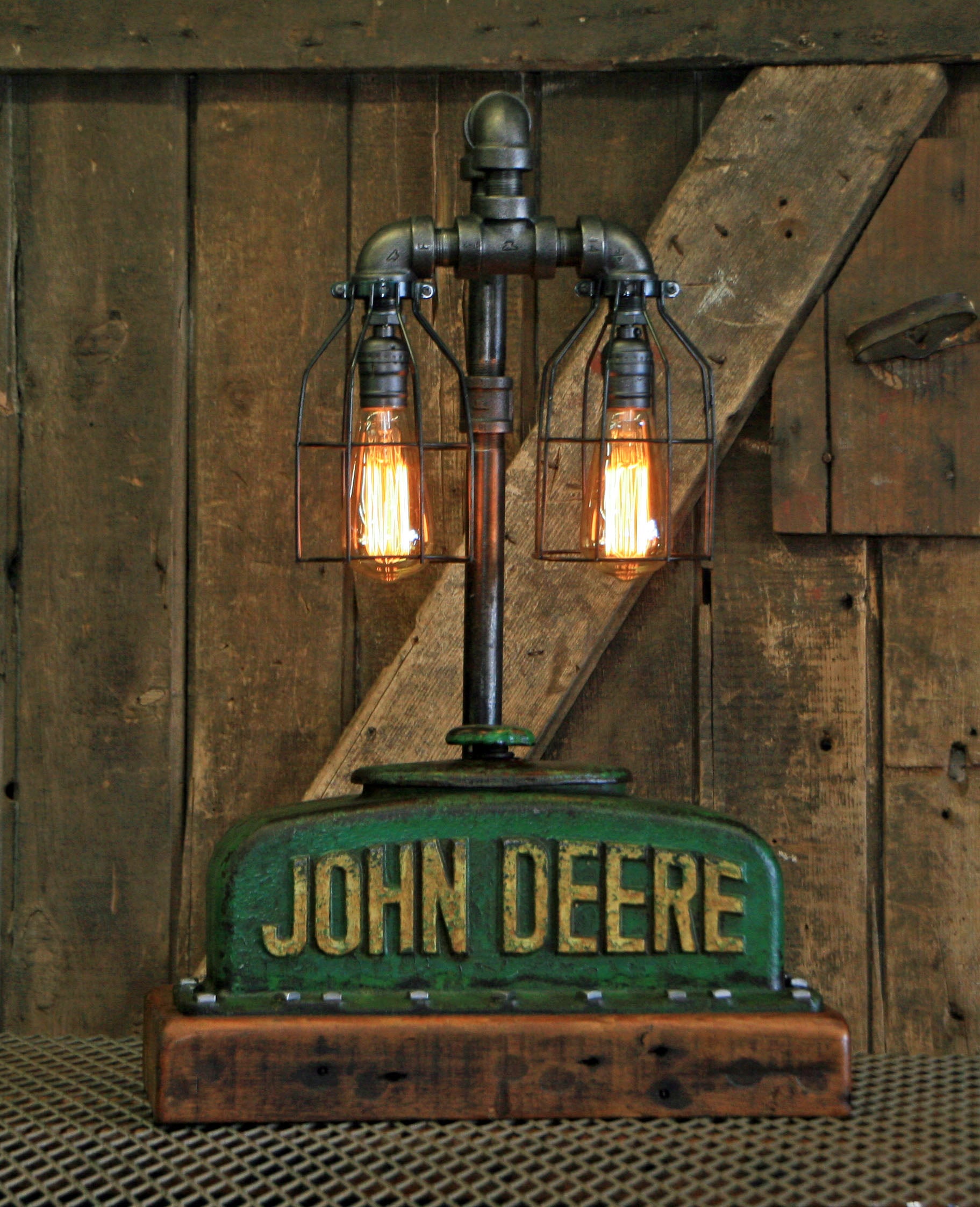 authentic John Deere radiator top with its original patina and a rustic barn wood base