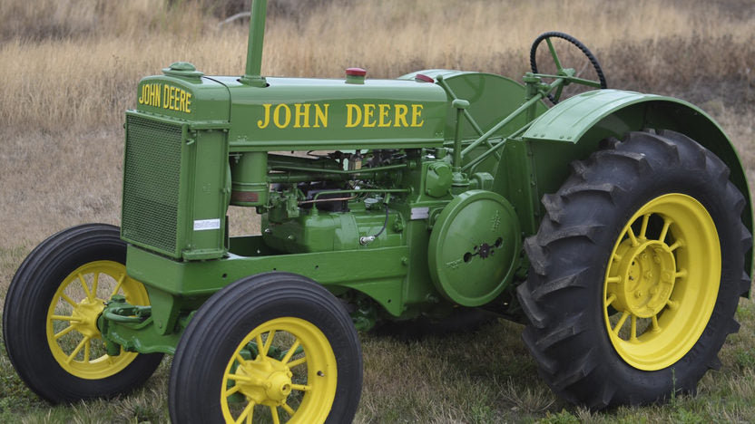 John Deere tractor outside in a field of grass